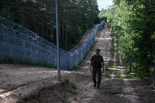 DIEVENISKES, LITHUANIA - JULY 10: A Lithuanian border guard officer patrols along the Belarus???Lithuania border on July 10, 2023 in Dieveniskes, Lithuania. Members and partner countries heads of state will travel to Lithuania for the NATO Summit from July 11-12 to chart the alliance's future, with Sweden's application for membership and Russia's ongoing war in Ukraine as major topics on the summit agenda. (Photo by Omar Marques/Getty Images)