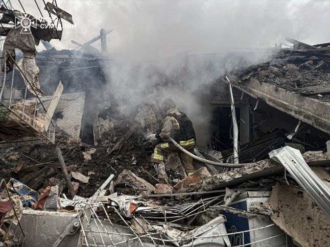 A rescuer works at the site where a store was hit by a Russian air strike, amid Russia's attack on Ukraine, in Sumy region, Ukraine, in this handout picture released December 11, 2025. Press service of the State Emergency Service of Ukraine in Sumy region/Handout via REUTERS ATTENTION EDITORS - THIS IMAGE HAS BEEN SUPPLIED BY A THIRD PARTY. MUST NOT OBSCURE LOGO.