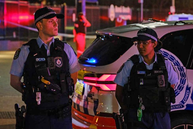SYDNEY, AUSTRALIA - DECEMBER 14: Police set up a cordon line at the scene of a mass shooting at Bondi Beach in on December 14, 2025 in Sydney, Australia. Two gunmen dressed in black fired several shots at Sydney's world-famous Bondi Beach, causing at least 10 injuries and three deaths, and setting off mass panic on a Sunday evening. (Photo by George Chan/Getty Images)