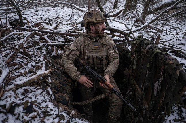 In this photo, taken Tuesday, Dec. 16, 2025 and provided by Ukraine's 93rd Kholodnyi Yar Separate Mechanized Brigade press service, a Ukrainian soldier looks searching for enemy's drones on his position near the frontline town of Kostyantynivka, the site of heavy battles with the Russian troops in the Donetsk region, Ukraine. (Iryna Rybakova/Ukraine's 93rd Mechanized Brigade via AP)
