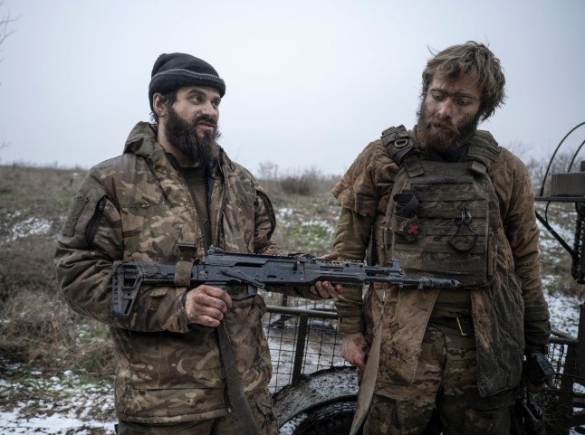 epa12598576 A handout picture made available by the press service of the 93rd Kholodnyi Yar Separate Mechanized Brigade of Ukrainian Armed Forces on 17 December 2025 shows servicemen of the 93rd Mechanized Brigade, Denis, call sign 'Bars', and Dmytro, call sign 'K2???, showing a trophy Russian weapon after returning from positions near the Kostyantynivka, where they fought for 130 days straight, in the Donetsk region, Ukraine, 16 December 2025, amid the ongoing Russian invasion. Russian troops entered Ukrainian territory on 24 February 2022, starting a conflict that has provoked destruction and a humanitarian crisis. EPA/Press service of the 93rd Separate Mechanized Brigade HANDOUT HANDOUT EDITORIAL USE ONLY/NO SALES