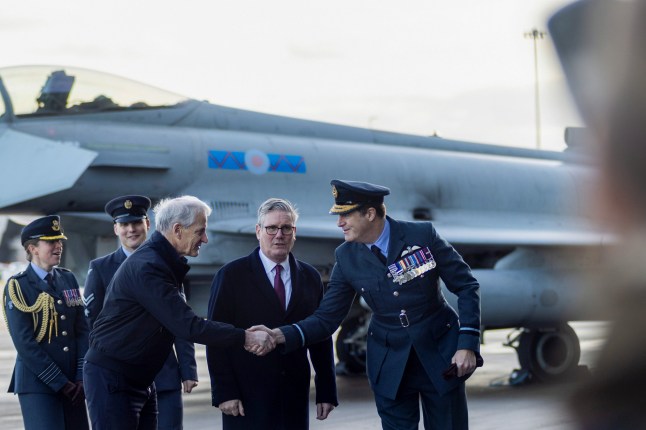 Jonas Gahr Store, Norway's prime minister, left, and Keir Starmer, UK's prime minister, centre, during a visit to RAF Lossiemouth air force base in Moray, UK, on Thursday, Dec. 4, 2025. Norway and the UK have signed a cooperation agreement that will see their armed forces working more closely together, including on purchasing of equipment. Photographer: Emily Macinnes/Bloomberg via Getty Images