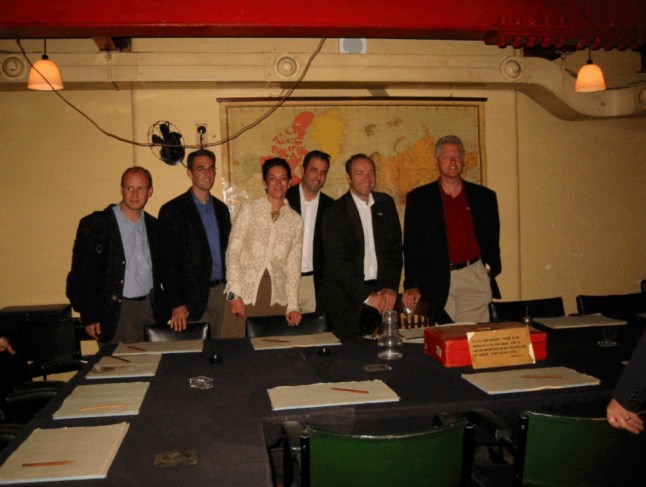 This undated photo released by the U.S. Department of Justice shows Ghislaine Maxwell, third from left, actor Kevin Spacey, second from right, and former President Bill Clinton, far right, with a group of unknown people.