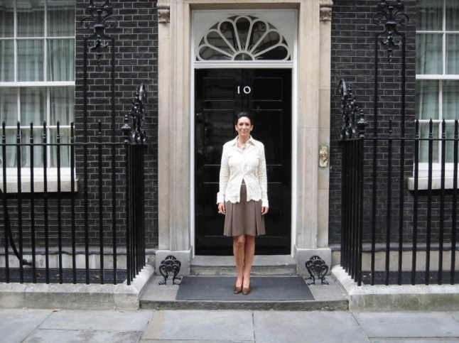 Ghislaine Maxwell poses in an undated photograph outside the British prime minister's residence of 10 Downing Street in London, Britain in this image released by the Department of Justice in Washington, D.C., U.S., on December 19, 2025 as part of a new trove of documents from its investigations into the late financier and convicted sex offender Jeffrey Epstein. U.S. Justice Department/Handout via REUTERS THIS IMAGE HAS BEEN SUPPLIED BY A THIRD PARTY