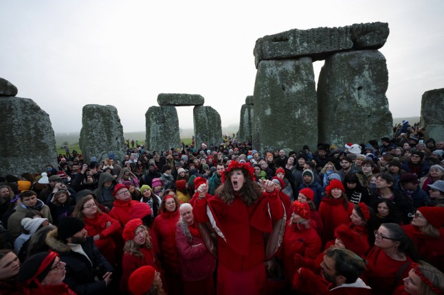 Revellers attend winter solstice celebrations during sunrise at Stonehenge stone circle near Amesbury, Britain, December 21, 2025. REUTERS/Isabel Infantes