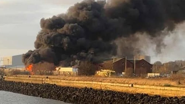 Huge blaze erupts near harbour as multiple lorries and trailers on fire