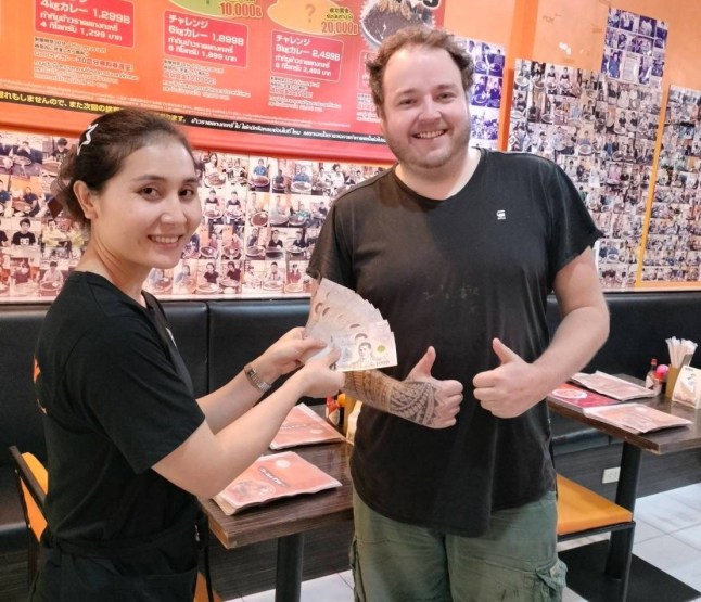 A German Michelin-trained chef allegedly cheated at a restaurant's curry-eating challenge to win a cash prize. Sebastian Schwesinger, 37, (PICTURED WINNING 20,000 BAHT ON HIS SECOND FOOD CHALLENGE) took on a whopping 10 kilogrammes (22 lbs) plate of curry and rice at a restaurant in Bangkok, Thailand. But he was caught appearing to cheat when staff saw him scooping up mounds of sauce-covered rice into his backpack on December 17. Footage shows Sebastian, from Leipzig, checking to see if he was being watched before stealthily disposing of the food in the bag next to him. Staff later confronted him and demanded that he pay for the meal. They investigated and claimed he had cheated at two other locations and collected the prize money before being caught. PACKAGE: Video, pictures, text