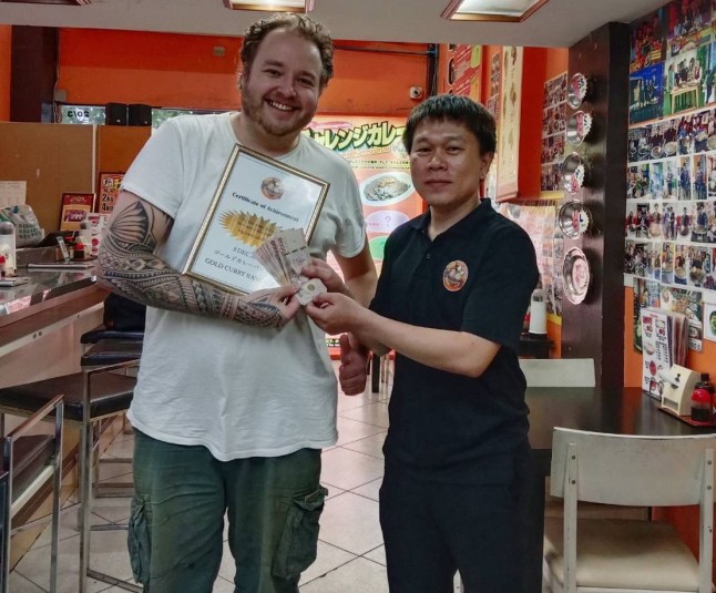 A German Michelin-trained chef allegedly cheated at a restaurant's curry-eating challenge to win a cash prize. Sebastian Schwesinger, 37, (PICTURED WINNING 10,000 BAHT ON HIS FIRST FOOD CHALLENGE) took on a whopping 10 kilogrammes (22 lbs) plate of curry and rice at a restaurant in Bangkok, Thailand. But he was caught appearing to cheat when staff saw him scooping up mounds of sauce-covered rice into his backpack on December 17. Footage shows Sebastian, from Leipzig, checking to see if he was being watched before stealthily disposing of the food in the bag next to him. Staff later confronted him and demanded that he pay for the meal. They investigated and claimed he had cheated at two other locations and collected the prize money before being caught. PACKAGE: Video, pictures, text
