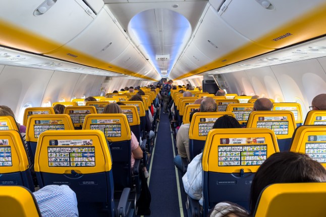 England - March 09, 2024; Passengers seated inside an airborne Ryanair 8200 plane; Shutterstock ID 2445379937; purchase_order: -; job: -; client: -; other:
