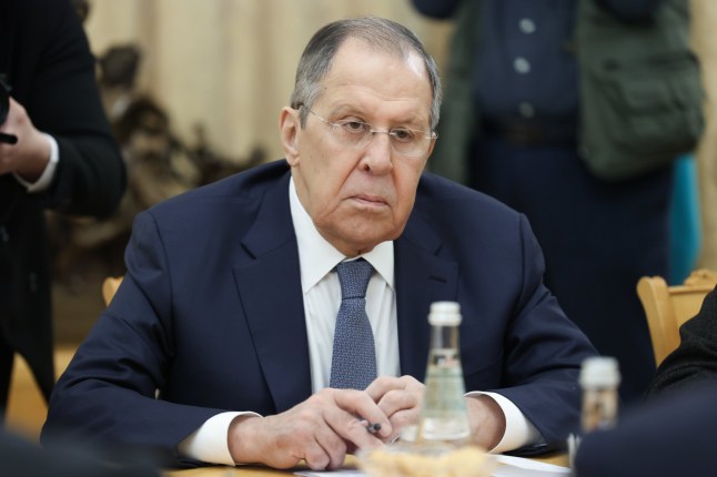 Russian Foreign Minister Sergey Lavrov dressed in a suit and sat down at a conference