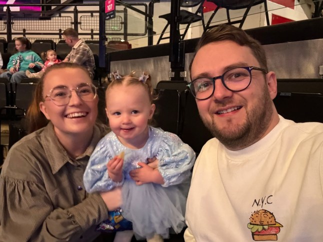 Isobel is pictured with her parents, Tamara and Aaron / A two-year-old girl has died after falling in a garden pond moments after going missing during a family gathering on Christmas Day. The toddler, named Isobel, is said to have wandered into her parents' garden in Doncaster, South Yorkshire, while the family were playing with their presents on December 25.