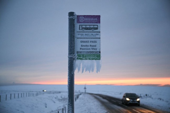 A photograph taken on January 8, 2025 shows a bus stop covered in ice, at the top of the Snake pass road, in the Peak district, northern England, after heavy snow and rain across large parts of England caused disruption over the weekend. (Photo by Oli SCARFF / AFP) (Photo by OLI SCARFF/AFP via Getty Images)