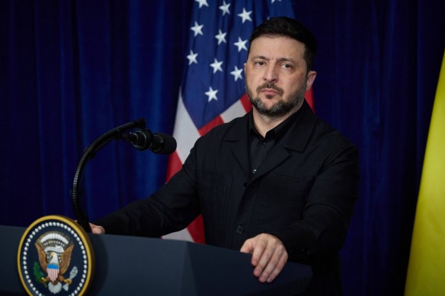 Ukrainian President Volodymyr Zelensky stands behind a lecturn at a meeting with President Donald Trump in Florida, US