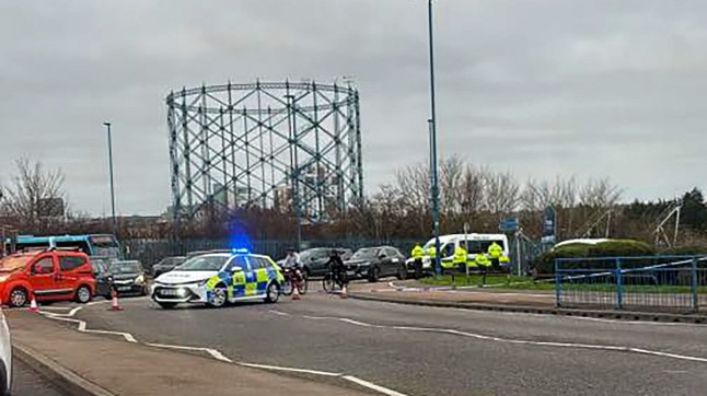 A wide shot of police cars and a police van on an A-road in Gillingham, Kent following a collision