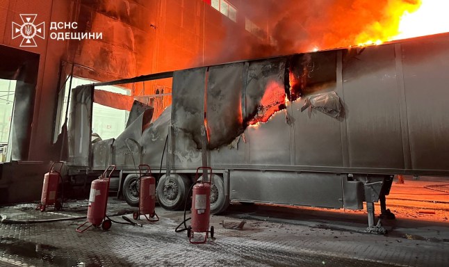 A cargo semi truck burns at a compound of logistics centre after it was hit during an overnight Russian drone strike, amid Russia's attack on Ukraine, in Odesa, Ukraine, December 31, 2025. Press service of the State Emergency Service of Ukraine in Odesa region/Handout via REUTERS ATTENTION EDITORS - THIS IMAGE HAS BEEN SUPPLIED BY A THIRD PARTY. DO NOT OBSCURE LOGO.