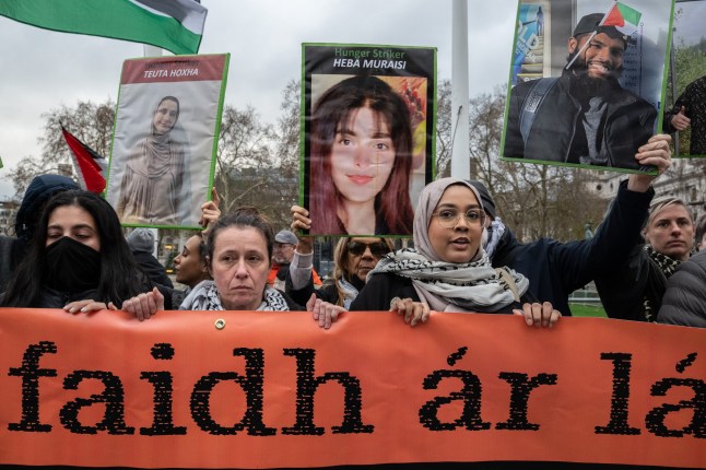 LONDON, ENGLAND - DECEMBER 15: Supporters of the Palestine Action hunger strikers protest in Parliament square while waiting for the Derry delegation on December 15, 2025 in London, England. Demonstrators are gathering to greet a delegation from Derry City and Strabane District Council who are meeting with families of Palestine Action (PA) prisoners on hunger strike. Last month the council in Northern Ireland voted to pass a motion in solidarity with the group of PA prisoners who have gone on hunger strike to demand for the closure of Elbit Systems sites in the UK, the lifting of the government's proscription against Palestine Action, and the right to fair trials. (Photo by Guy Smallman/Getty Images)