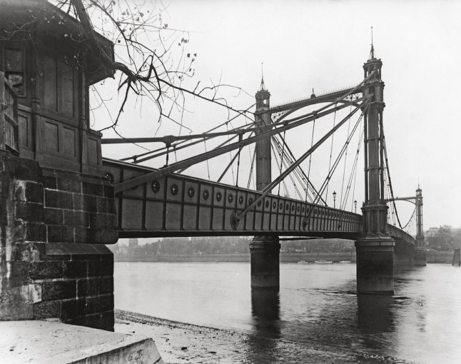 Albert Bridge in London, designed by Rowland Mason Ordish, which spans the Thames between Chelsea and Battersea, circa 1935.