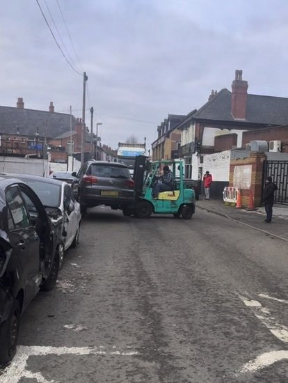 Story from Jam Press (Forklift Moves Car) Pictured: A video grab of an irritated forklift driver picking up and moving a Volkswagen Tiguan SUV, which was blocking a lorry's entrance. VIDEO: Truck off! Irritated forklift driver picks up and moves car blocking entrance allowing lorry to make its delivery An irritated forklift driver has been spotted picking up and moving a car which was blocking a lorry's entrance. Ahmed Hussain was left in stitches after he spotted an entire car being lifted out of the way for a truck to enter a yard. The 28-year-old was out on a job when he spotted the bizarre scene. The Volkswagen Tiguan SUV was left in a no-parking zone, which blocked the entrance to the business's yard. Ahmed from Haven Autocare, based in Digbeth, Birmingham, watched on as the worker lifted the vehicle out of the way. The talented forklift operator moved the vehicle and safely placed it further down the road on Studley Street, Sparkbrook, Birmingham. The lorry was then able to turn into the yard to drop off its deliveries. The owner did not return before the 28-year-old from Small Heath, Birmingham, whose job was finished on 30 December. ?The owner wasn?t back for a while,? Ahmed told?Luxury Auto News. ?It wasn?t blocking my business, but it was parked in a no-parking area. ?My business is not based in that area, but I provide mobile services, so I was just waiting for the customer at his place. ?The forklift, I believe, was from the business that was expecting a delivery from the lorry, as you can see in the clip. ?The car was parked there when I got there, so I would say it was there from early morning. ?The truck was delivering food or clothing items to the local shops.? ENDS EDITOR'S NOTE: Video Editors, please note that the car and lorry registration numbers are not?pixellated in the footage. Video Usage Licence: (EXCLUSIVE) We have obtained an exclusive licence from the copyright holder. A copy of the licence is available on request. Video Restrictions: None.