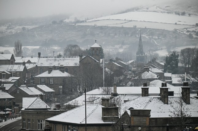 Snowy rooftops are pictured in the town of Glossop, Derbyshire, northern England on January 6, 2026, after a light snow covered the region overnight. The UK's Met Office issued fresh weather warnings for January 5-6 for snow and ice for Scotland, Northern Ireland and parts of northern England and said cold weather health alerts for all English regions would remain in place until January 9. (Photo by Oli SCARFF / AFP via Getty Images)
