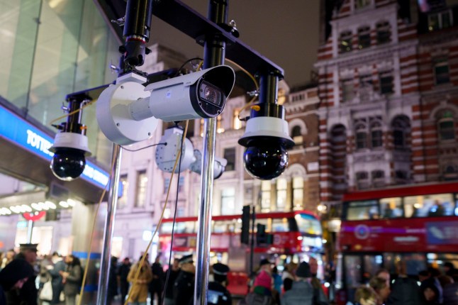 Met police Facial recognition cameras watch over Christmas shoppers outside Tottenham Court Road station, on 1st December 2025, in London, England. Facial Recognition (FR) technology is used by the Met to prevent and detect crime, find wanted criminals, safeguard vulnerable people. Real time surveillance helps officers locate people on a 'watchlist' who are sought by the police. FR cameras focus specific areas and when people pass through, their images are streamed directly to the Live Facial Recognition system and compared to a watchlist. Photo by Richard Baker / In Pictures via Getty Images)