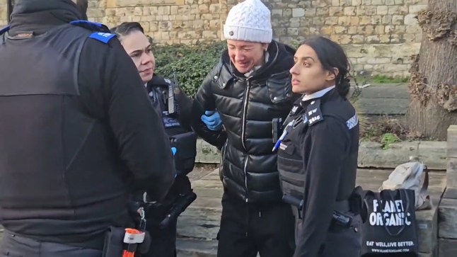 A woman in tears and in handcuffs after being arrested by Metropolitan Police officers and local council enforcement officers