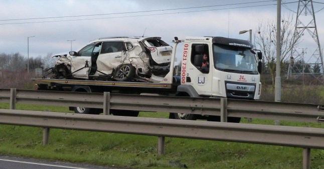 A badly damaged car is being towed away from the scene of a crash on the A130 in Essex which left police and paramedics seriously injured.
