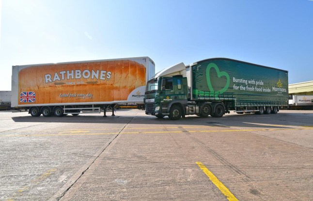 Wide shot of two HGV vehicles facing each other with Morrisons branding and Rathbones Bakery branding on the side of the lorries