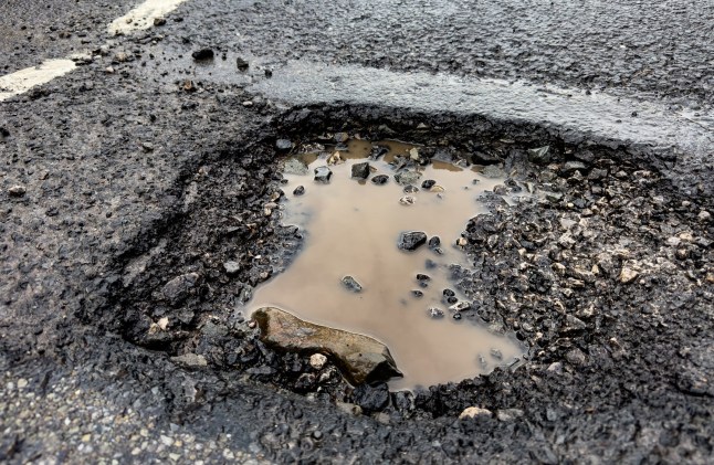 Pot hole on a public road starting to fill with water