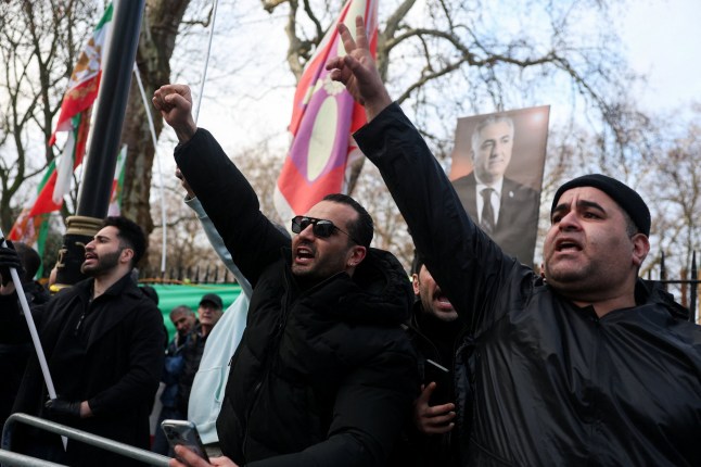 Demonstrators gesture outside the Iranian embassy during a rally in support of nationwide protests in Iran, in London, Britain, January 12, 2026. REUTERS/Toby Melville