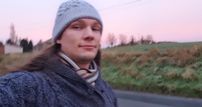 Selfie of a man with long hair wearing a beanie