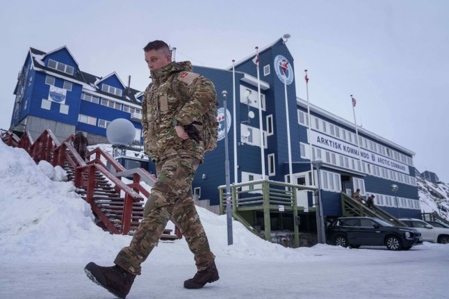 FILE - A Danish serviceman walks in front of Joint Arctic Command center in Nuuk, Greenland, on Jan. 16, 2026. (AP Photo/Evgeniy Maloletka, File)